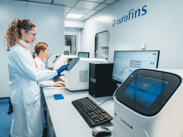 Two female scientists in a Eurofins laboratory conducting  Toxicological Evaluation, showcasing advanced equipment and expertise in BioPharma Product Testing within a high-precision research environment. 