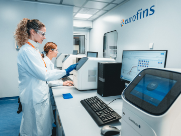 Two female scientists in a Eurofins laboratory conducting Environmental Monitoring and Utility Testing, showcasing advanced equipment and expertise in BioPharma Product Testing within a high-precision research environment. 