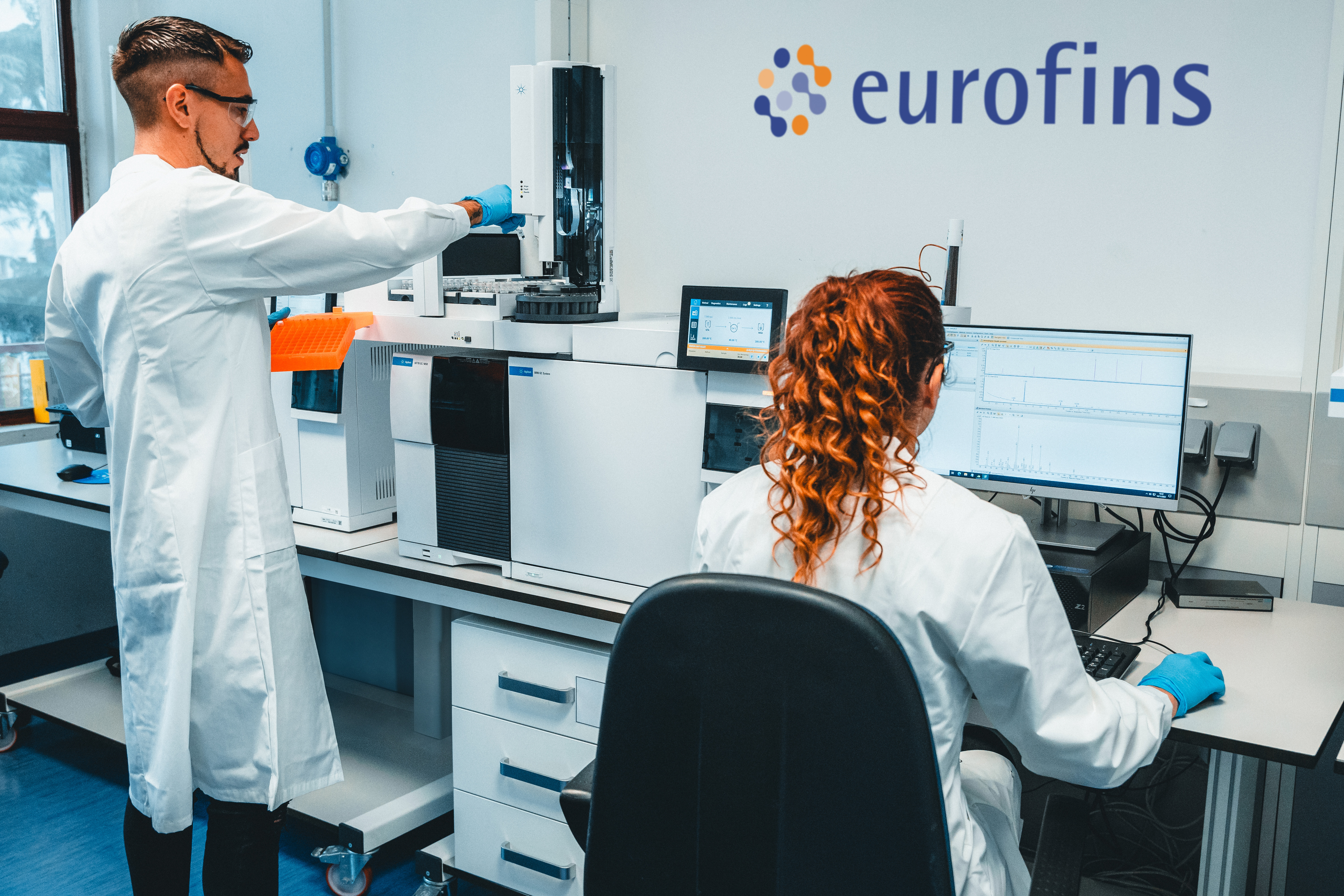Two scientists in a Eurofins laboratory conducting Chromatography, showcasing advanced equipment and expertise in BioPharma Product Testing within a high-precision research environment.